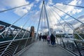 People walk on Queen`s Golden Jubilee Footbridges Royalty Free Stock Photo