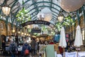 Visitors in Covent Garden`s popular Apple Market decorated for Christmas. The Market is a great Royalty Free Stock Photo