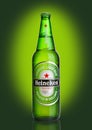 LONDON,UK -OCTOBER 23, 2016: Bottle of Heineken Lager Beer on green background. Heineken is the flagship product of Heineken Inter Royalty Free Stock Photo