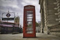 Classic London telephone booth next to an Underground station Royalty Free Stock Photo