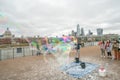 London, UK - October 2019: Giant soap bubbles show - street performers entertain tourists Royalty Free Stock Photo