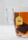 LONDON, UK - OCTOBER 21, 2020: Lipton yellow label tea bag in clear glass cup on white