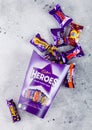 LONDON, UK - OCTOBER 10, 2019: Opened Gift box of Heroes mix chocolate candies on light table background. Dairy Milk, Wispa, Twirl