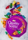 LONDON, UK - OCTOBER 10, 2019: Opened Gift box of Nestle Quality Street mix chocolate candies on light background