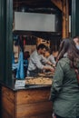 Staff working at the Furness Food Hut stall inside Borough Market, London, UK