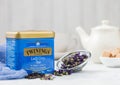 LONDON, UK - OCTOBER 21, 2020: Steel jar of Twinings Lady Grey loose tea with ceramic teapot and cane sugar on white