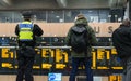 LONDON, UK - October 17th, 2017: british transport police officer watching Travelers watching the information departure