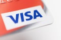 London / UK - October 9th 2019 - VISA logo on red bank card, closeup macro view with a shallow depth of field