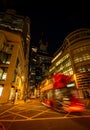 London, UK: Red London bus with motion blur on Gracechurch Street in the City of London at night