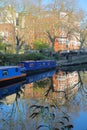 LONDON, UK: Reflections in Little Venice with colorful barges along canals