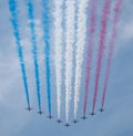 Nine Red Arrows RAF planes fly in formation giving off red white and blue smoke trails at the Trooping the Colour parade, London