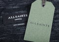 LONDON, UK - SEPTEMBER 09, 2020: ALLSAINTS label and clothing tag on cotton fabric Royalty Free Stock Photo