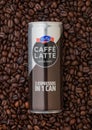 LONDON, UK - SEPTEMBER 09, 2020: Aluminium can of Emmi Caffe Latte Extra Shot inside fresh raw coffee beans