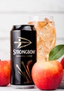 LONDON, UK - SEPTEMBER 13, 2018: Aluminium can and glass of Strongbow Original Cider with fresh apples on wooden background.