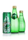 LONDON, UK - SEPTEMBER 03, 2018: Bottles and aluminium tin of Perrier sparkling water on white. Perrier is a French brand of natur Royalty Free Stock Photo