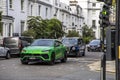 London, UK - September 14, 2023: Green Lamborghini Urus with green traffic light in central London