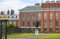 Kensington palace, in Hyde park view at sunny day with lots of people walking and resting in th, London UK