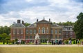 Kensington palace, queen Victoria monument in Hyde park view at sunny day with lots of people walking and resting in th, London UK Royalty Free Stock Photo