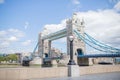 The Iconic Tower Bridge Behind a Lamppost and Under a Cloudy Blue Sky Royalty Free Stock Photo