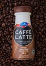 LONDON, UK - SEPTEMBER 09, 2020: Plastic bottle of Emmi Caffe Latte cappuccino iced coffee inside fresh raw coffee beans