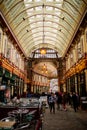 Portrait View of People Walking on an Alley Under an Arched Ceiling