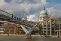 St Pauls Cathedral and the Millennium Bridge in London, United Kingdom during a cloudy day Royalty Free Stock Photo