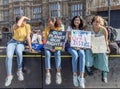 London / UK - September 20th 2019 - Young female climate change activists hold signs while demonstrating at the Climate Strike