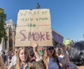 London / UK - September 20th 2019 - Young female climate change activists hold signs saying Wake Up and Smell the Smoke