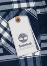 LONDON, UK - SEPTEMBER 09, 2020:Timberland logo and clothing tag on black and white shirt fabric Royalty Free Stock Photo