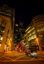 London, UK: Taxi cab and red London buses with motion blur on Gracechurch Street in the City of London at night