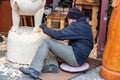 London, UK 5th January, 2020. Wood carver working on a large sculpture of Winnie the Pooh Royalty Free Stock Photo