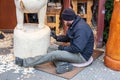 London, UK 5th January, 2020. Wood carver working on a large sculpture of Winnie the Pooh Royalty Free Stock Photo