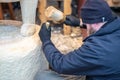 London, UK 5th January, 2020. Wood carver working on a large sculpture of Winnie the Pooh Royalty Free Stock Photo