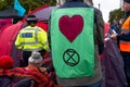 Police officer monitoring Extinction Rebellion protesters at Trafalgar Square London UK.