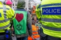 Metropolitan police officers monitoring Extinction Rebellion protesters at Trafalgar Square London UK. signtalkin