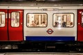 London UK - Underground train in tunnel in London - District Line with people viewed inside showing through windows