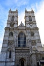 Westminster Abbey. West gothic facade and towers with clock, windows and statues. London, United Kingdom. Royalty Free Stock Photo