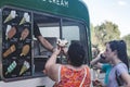 Woman buying soft serve ice cream in Ice cream van