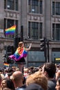 Woman climbs up the traffic light at Oxford Circus, London, to get a better view of the Gay Pride Parade.