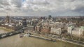 London under a moody sky. London Eye with view of Big Ben across the river Thames with sepia skyscape. Royalty Free Stock Photo