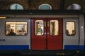 London Underground train on a station platform, people seen though the window, London, UK Royalty Free Stock Photo