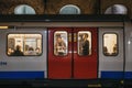 London Underground train on a station platform, people seen though the window, London, UK Royalty Free Stock Photo