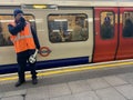 London underground train and TFL worker nad passengers Royalty Free Stock Photo