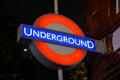 London Underground Tube Station sign lit at night Royalty Free Stock Photo