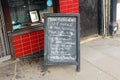 London, United Kingdom - April 27, 2020: Chalk hand written notice on blackboard in front of John Charles Butchers shop about