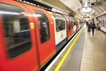 London, United Kingdom. August 22, 2010. Mouving train arriving at subway station. British tube rail station, selective focus Royalty Free Stock Photo