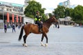 Policewoman on leads traffic from horseback near Tower of London. Police on horseback in the UK for the prevention of