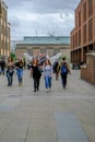 London, United Kingdom - August 3, 2017: Tourists crossing over Millenium Royalty Free Stock Photo