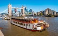 Tower bridge over Thames river on a sunny day with wharf and boats. City Financial