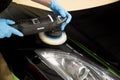 LONDON, UNITED KINGDOM - Feb 17, 2017: Detailer using Rupes rotary machine polishing a sports car